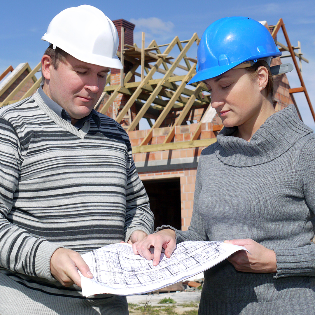 two contractors viewing house plans